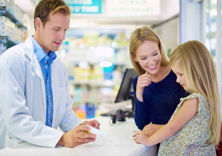 pharmacist-helping-mother-and-child-at-pharmacy-travel-vaccine-consultation