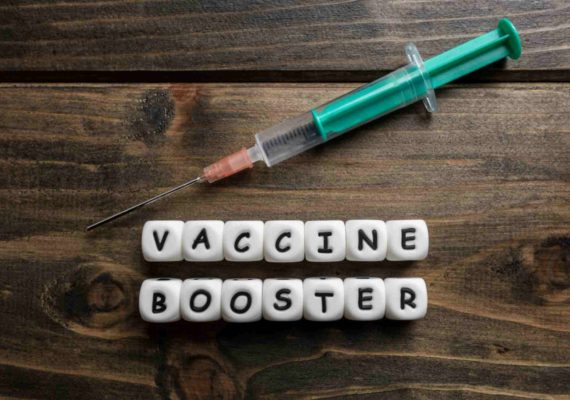 syringe-and-booster-doses-on-a-rustic-table